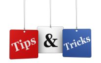 Three hanging signs with the words "Tips" and "Tricks" written on them.